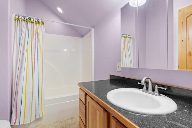 bathroom with vaulted ceiling, shower / bath combination with curtain, and vanity