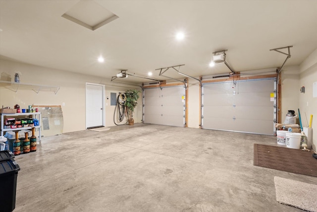 garage with electric panel and a garage door opener