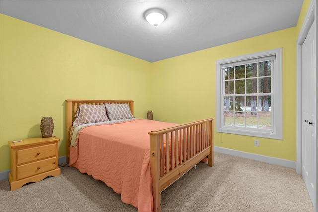 bedroom featuring carpet floors and baseboards