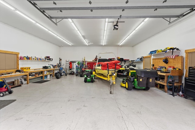 garage with a workshop area and a garage door opener