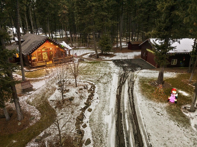 exterior space featuring driveway and a forest view