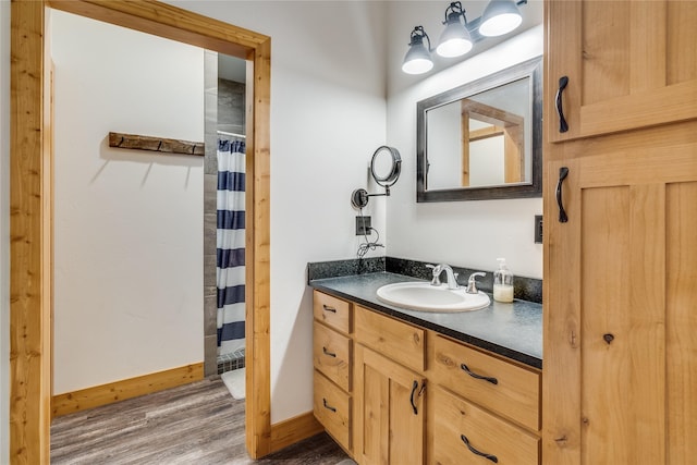 bathroom with vanity, wood-type flooring, and walk in shower