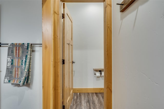 hallway with hardwood / wood-style floors