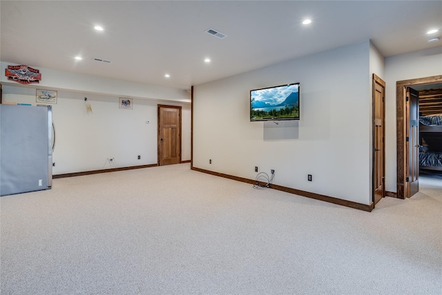 unfurnished living room with light colored carpet