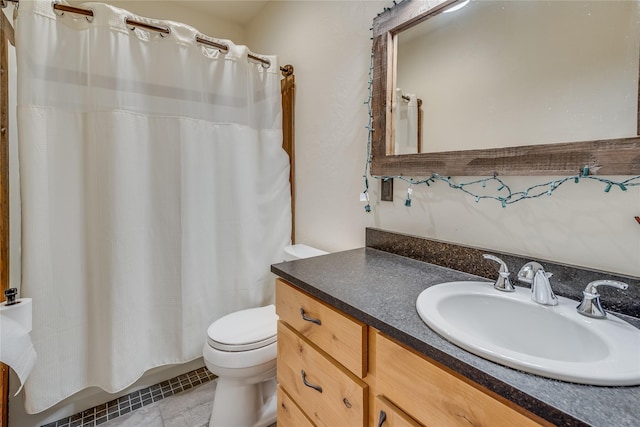 bathroom featuring tile patterned flooring, vanity, and toilet