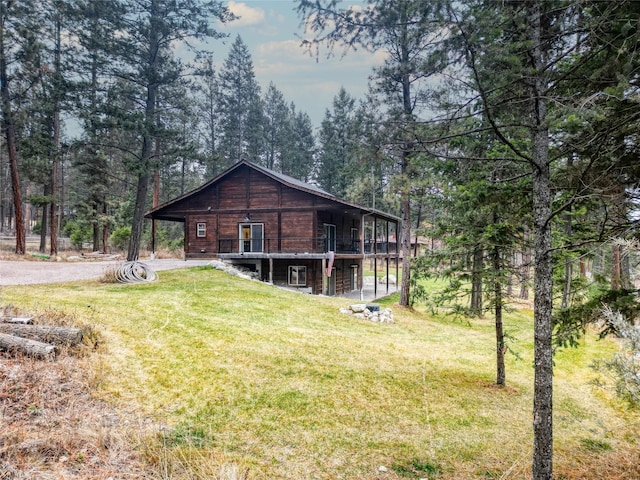 rear view of house featuring a lawn and a deck