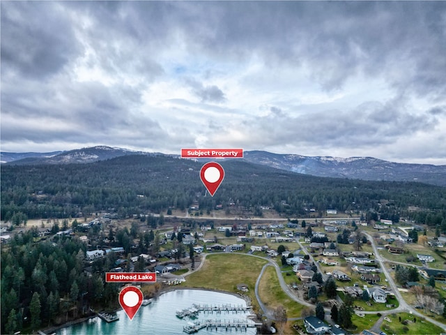 birds eye view of property with a water and mountain view