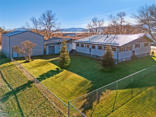 exterior space with metal roof, fence private yard, and a mountain view