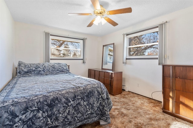 bedroom with a baseboard radiator, a ceiling fan, a textured ceiling, and light colored carpet