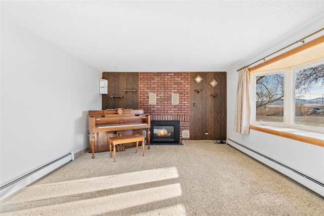 living area featuring a brick fireplace, wooden walls, a baseboard heating unit, and carpet flooring