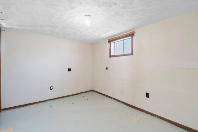 interior space with baseboards and a textured ceiling