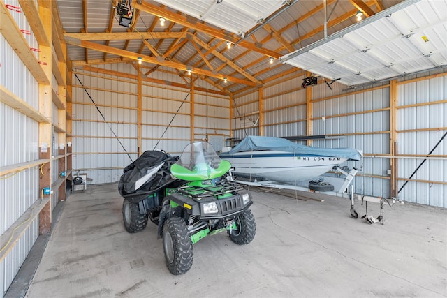 garage featuring a garage door opener and metal wall