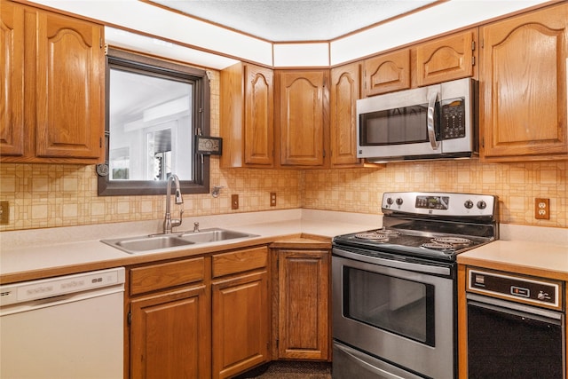 kitchen featuring a sink, stainless steel appliances, and light countertops