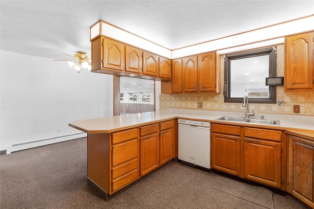 kitchen with a peninsula, white dishwasher, light countertops, a baseboard heating unit, and a sink