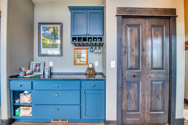 bar featuring blue cabinets