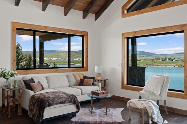 living area with baseboards, wooden ceiling, wood finished floors, vaulted ceiling with beams, and a water and mountain view