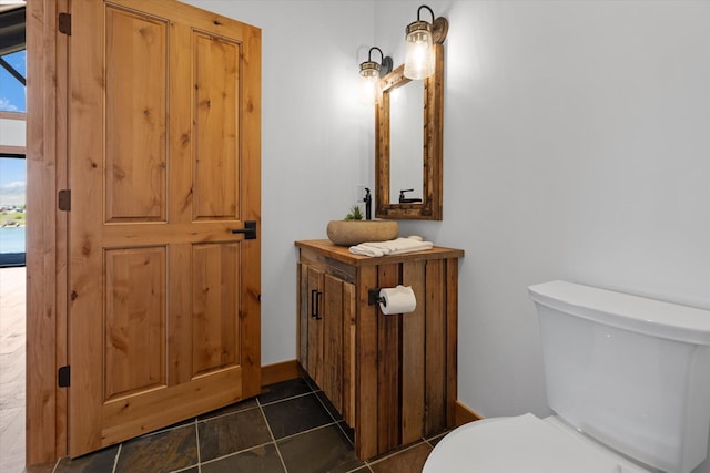 half bath with tile patterned flooring and toilet