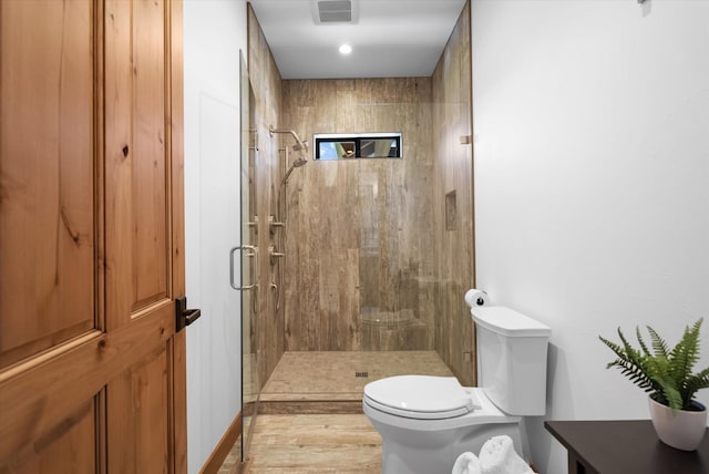 full bath with visible vents, a stall shower, wood finished floors, and toilet