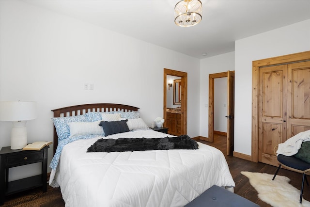 bedroom featuring an inviting chandelier, dark wood finished floors, and baseboards