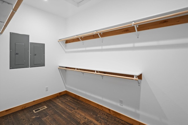 walk in closet with visible vents, wood finished floors, and electric panel