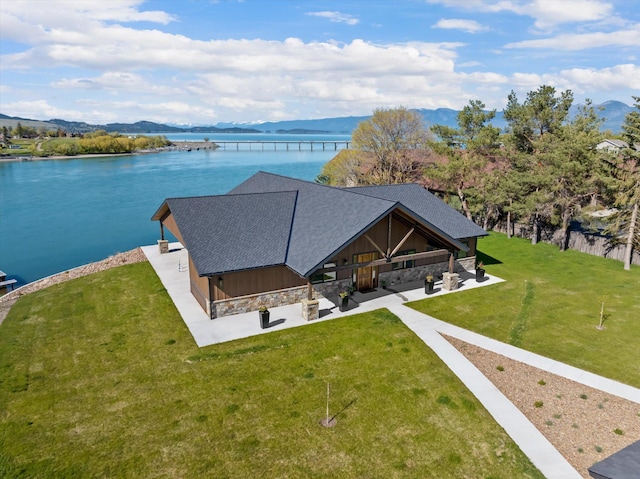 drone / aerial view featuring a water and mountain view