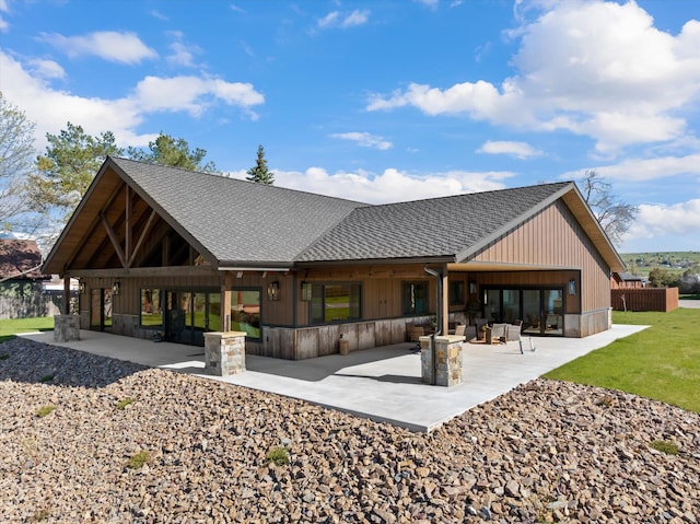 rear view of property featuring a shingled roof