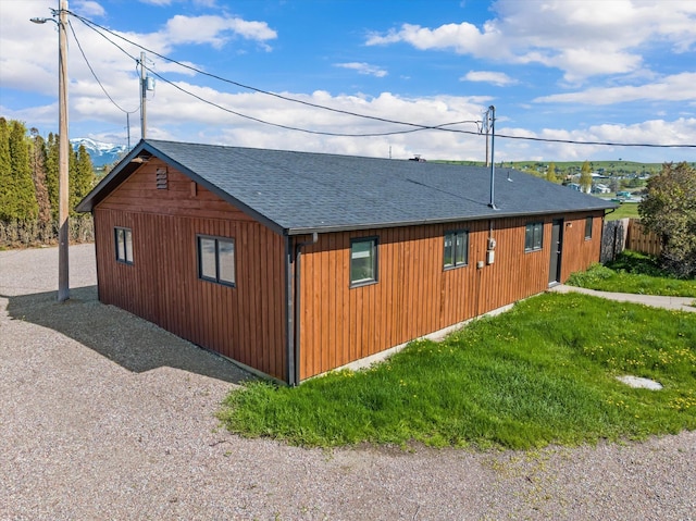 view of side of home featuring a shingled roof