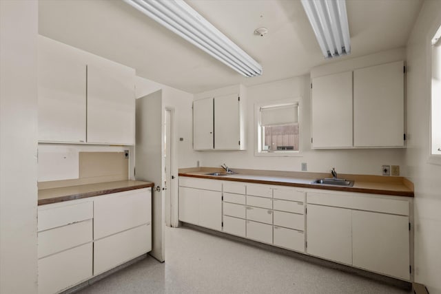 kitchen with white cabinets and a sink