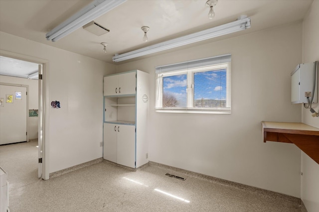 interior space featuring baseboards and visible vents