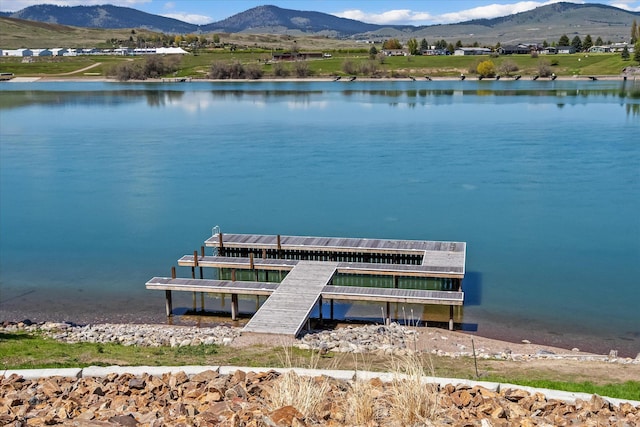 view of dock with a water and mountain view