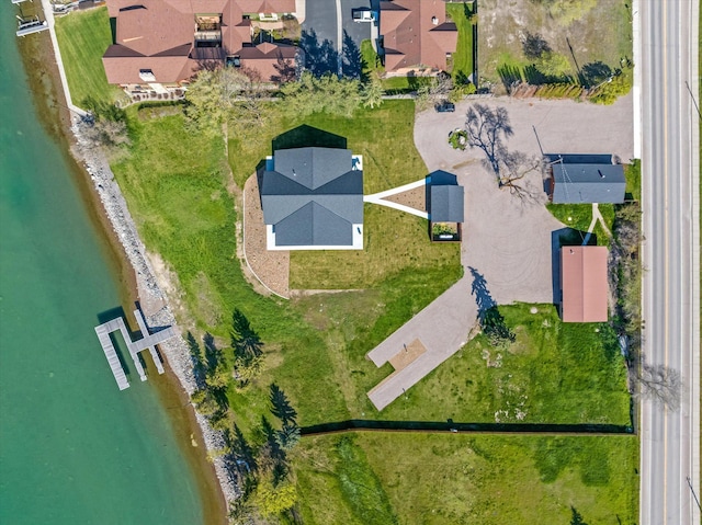 drone / aerial view featuring a water view and a residential view