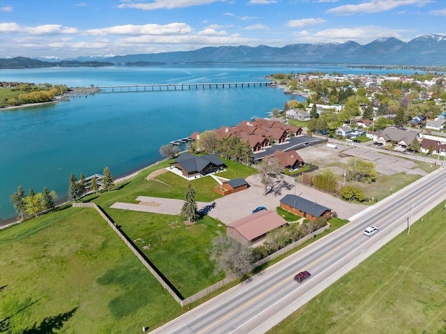 drone / aerial view featuring a residential view and a water and mountain view