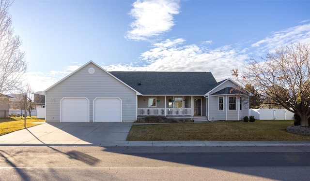 single story home with a porch, a front yard, and a garage