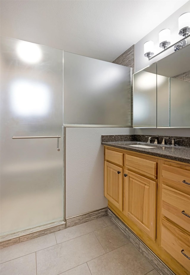 bathroom with tile patterned flooring, vanity, and an enclosed shower