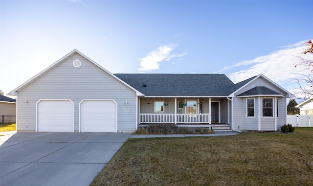 single story home featuring a porch, a front yard, and a garage