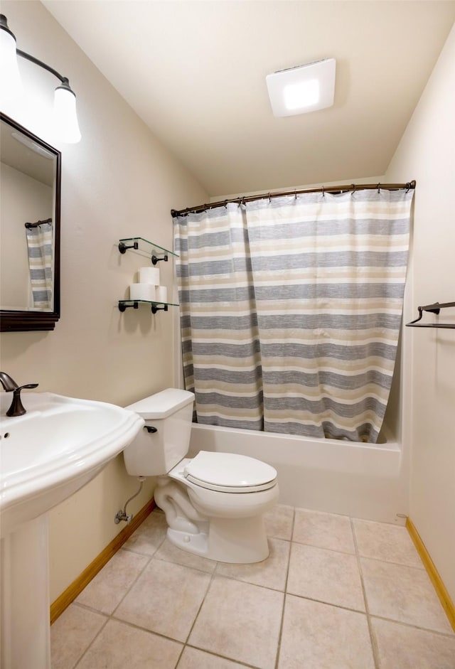 full bathroom featuring tile patterned flooring, toilet, sink, and shower / tub combo with curtain