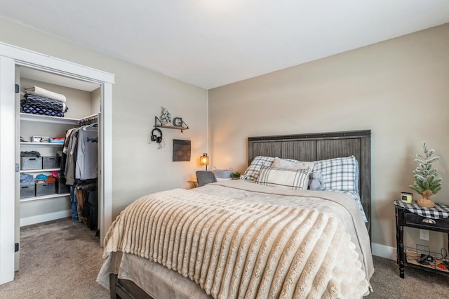 bedroom featuring light colored carpet, a spacious closet, and a closet