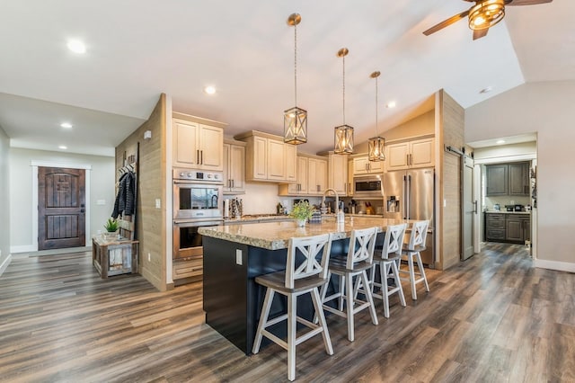 kitchen with lofted ceiling, a breakfast bar area, decorative light fixtures, dark hardwood / wood-style flooring, and stainless steel appliances