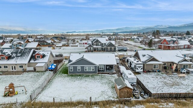 snowy aerial view featuring a mountain view