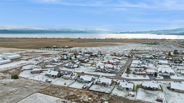 snowy aerial view featuring a mountain view