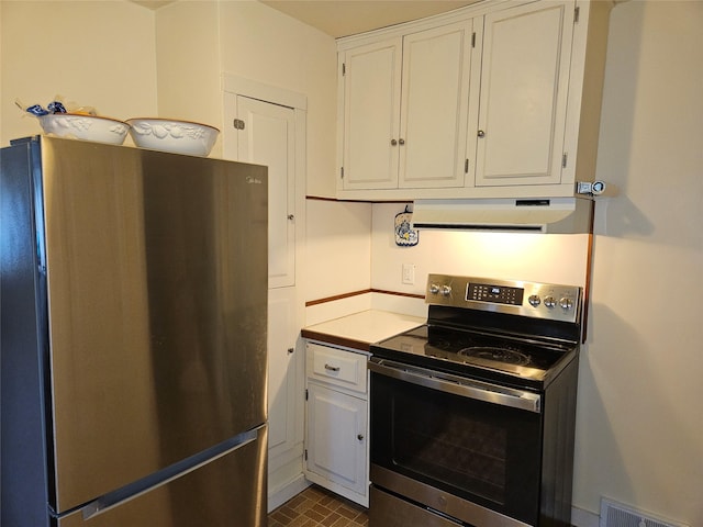 kitchen featuring white cabinets, stainless steel appliances, and exhaust hood