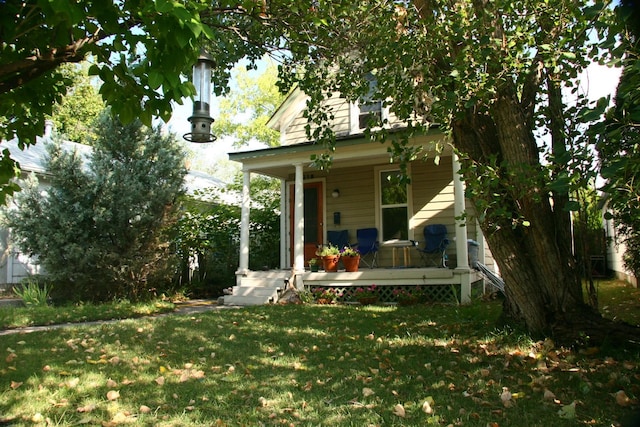 exterior space with a porch and a front yard