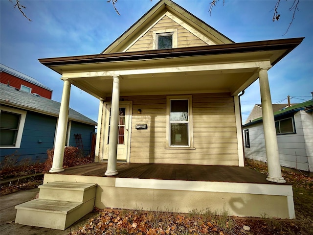 view of exterior entry with a porch