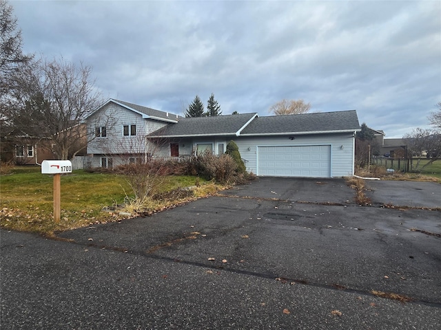 split level home with a front yard and a garage