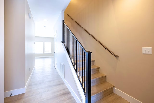 stairway featuring hardwood / wood-style floors