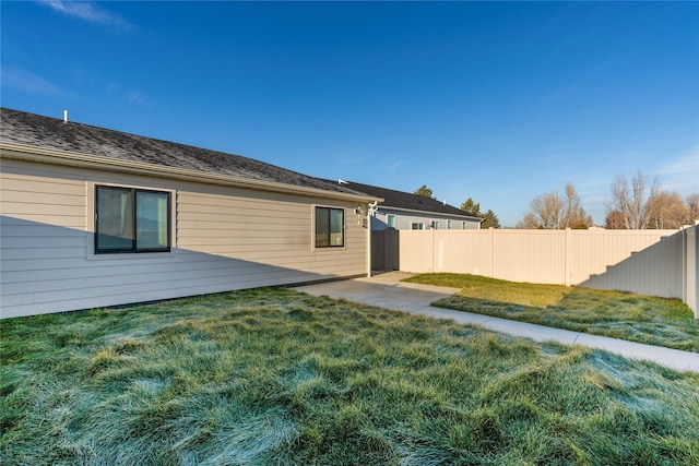 back of property with a patio and a lawn