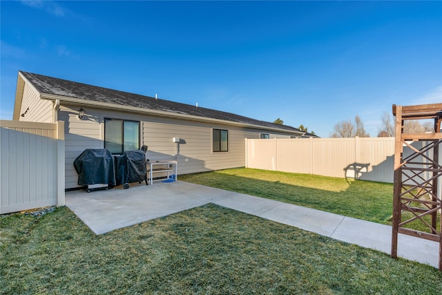 back of property featuring a lawn and a patio area