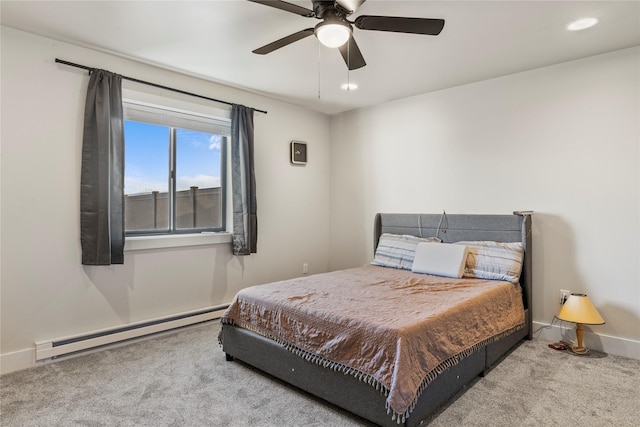 bedroom with carpet, ceiling fan, and a baseboard heating unit