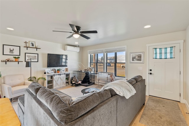 living room with an AC wall unit, ceiling fan, and light wood-type flooring