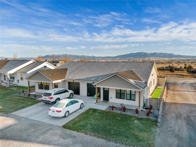 703 S Oak St Unit 1 & 2, Townsend, MT 59644 - view of front of house with a mountain view, driveway, an attached garage, and a front lawn